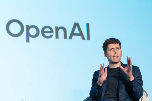 Sam Altman, in a dark suit, sits in front of a light blue background with the words "OpenAI"