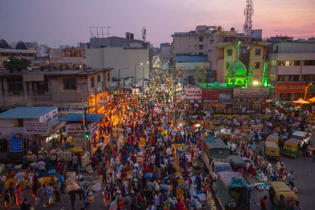 aerial view of crowds of people at a street market at dawn