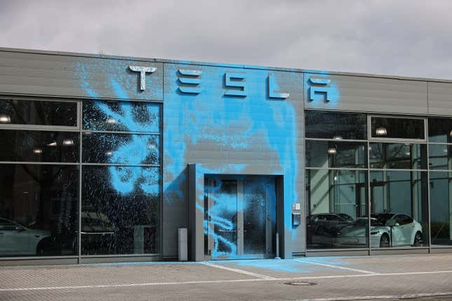 A Tesla car dealership stands doused in blue paint following vandalism by activists of the group New Generation on March 31, 2025 in Berlin, Germany. Tesla’s sales in Europe have been slammed in recent months.