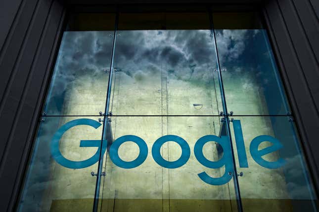 Google logo over a stormy-looking backdrop on a building