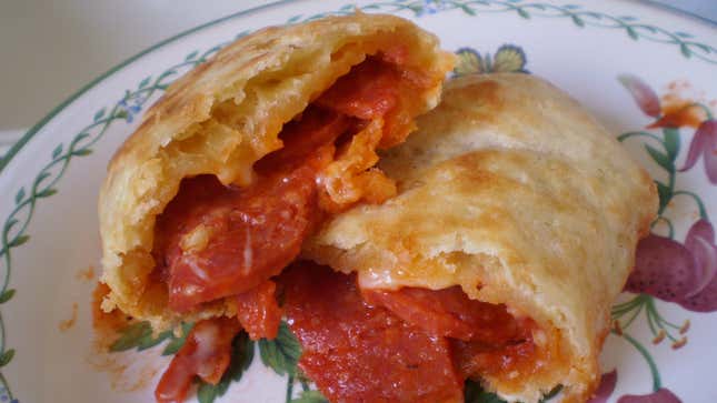 Cooked pepperoni hot pockets on a floral plate
