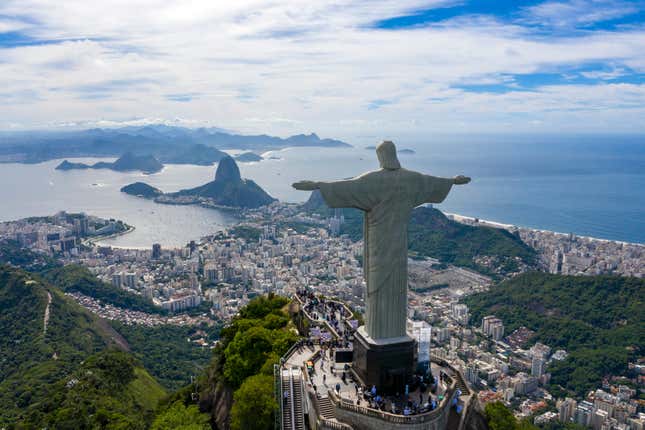 aerial view of the statue of Christ the Redeemer during the day overlooking the city and beach